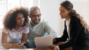 Couple discussing contract terms during meeting with realtor
