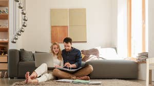 Couple with laptop looking at paperwork