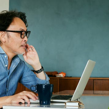 Man working on laptop and drinking coffee