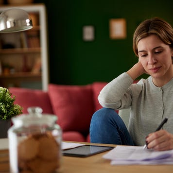 Women using digital tablet to check her finances at home office