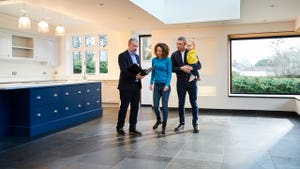 real estate agent showing a house to a family