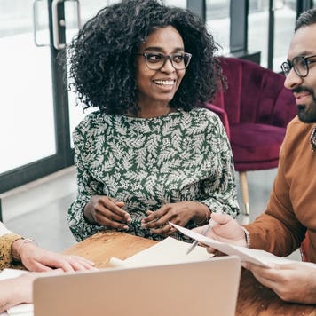 Homebuyers sign mortgage documents